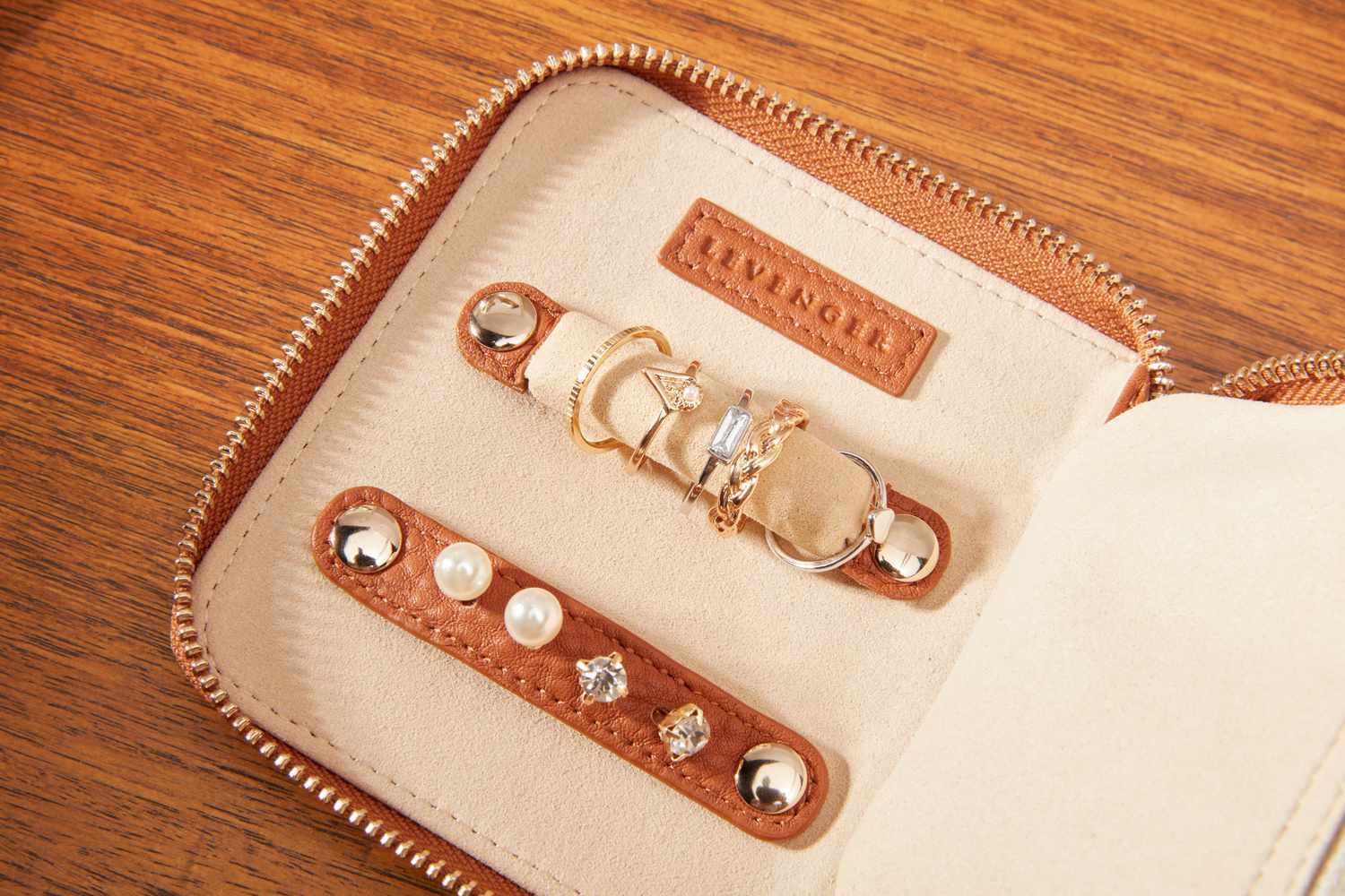 A close-up of the Levenger Carrie Mini Jewelry Organizer's earring and ring holder. 