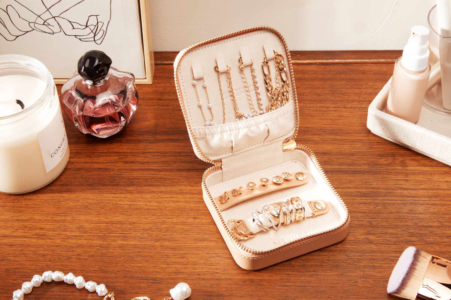 The Mejuri Jewelry Case filled with jewelry and sitting on a table. 
