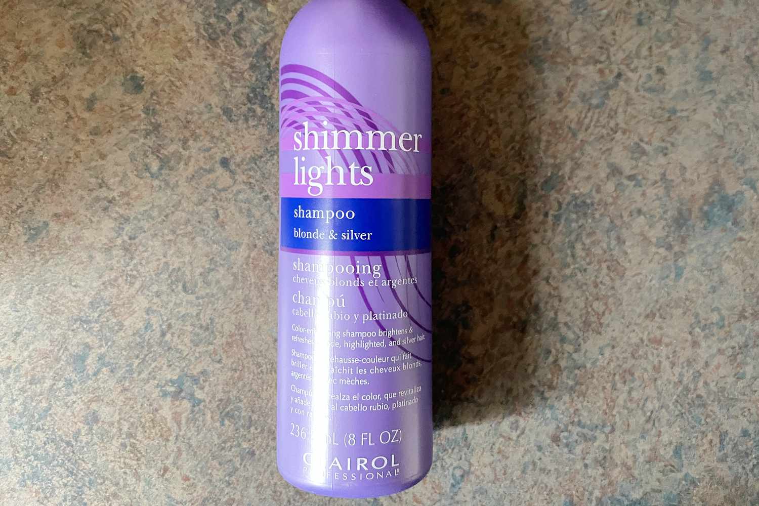 A bottle of Clairol Professional Shimmer Lights Purple Shampoo