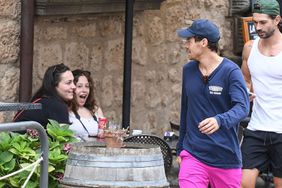 Harry Styles Out jogging with his personal trainer Brad Gould, the former One Direction Star is put through his paces as he donned his pink shorts, pounding the streets of Bagnoregio, Italy.