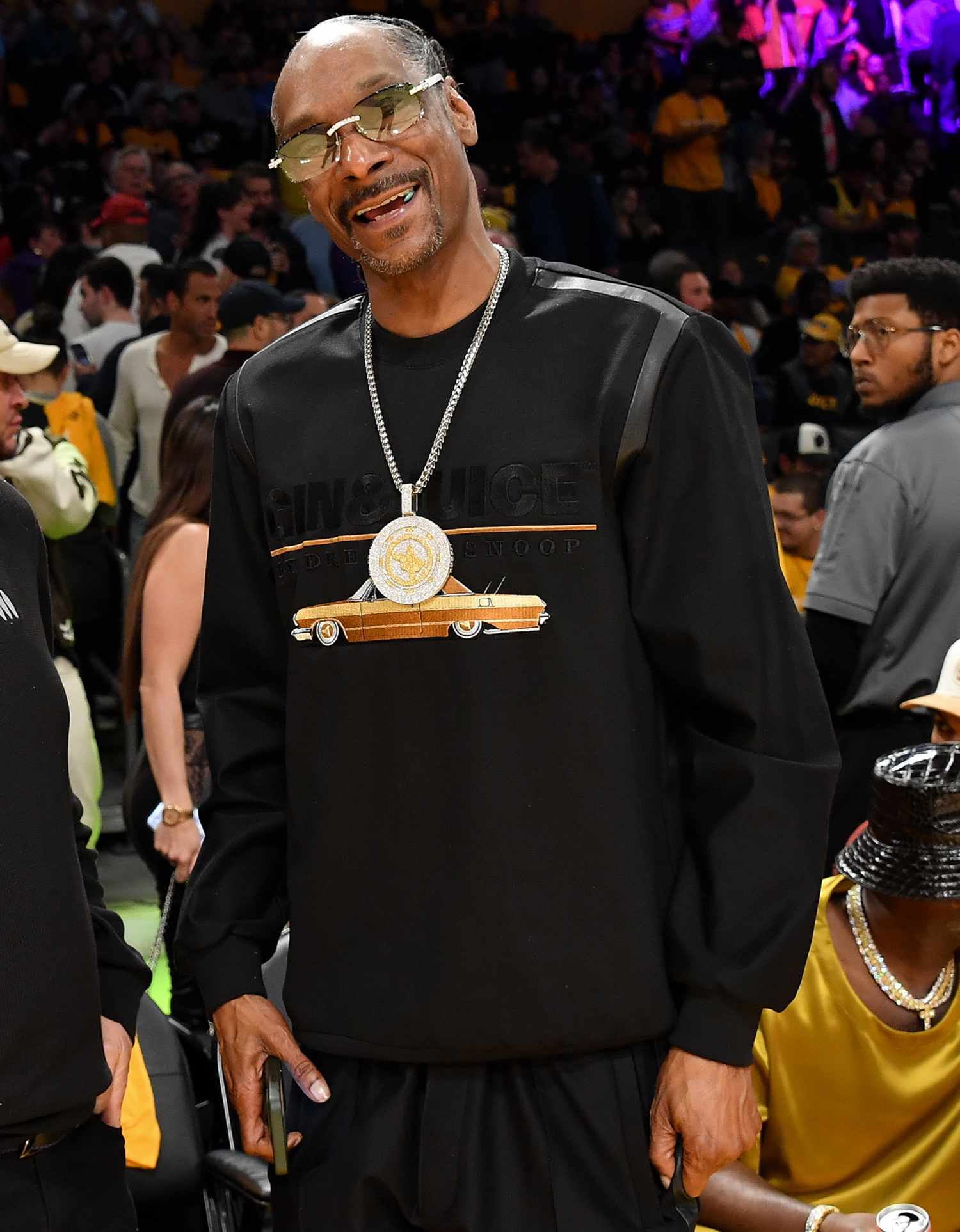 Snoop Dogg attend a basketball game between the Los Angeles Lakers and the Denver Nuggets