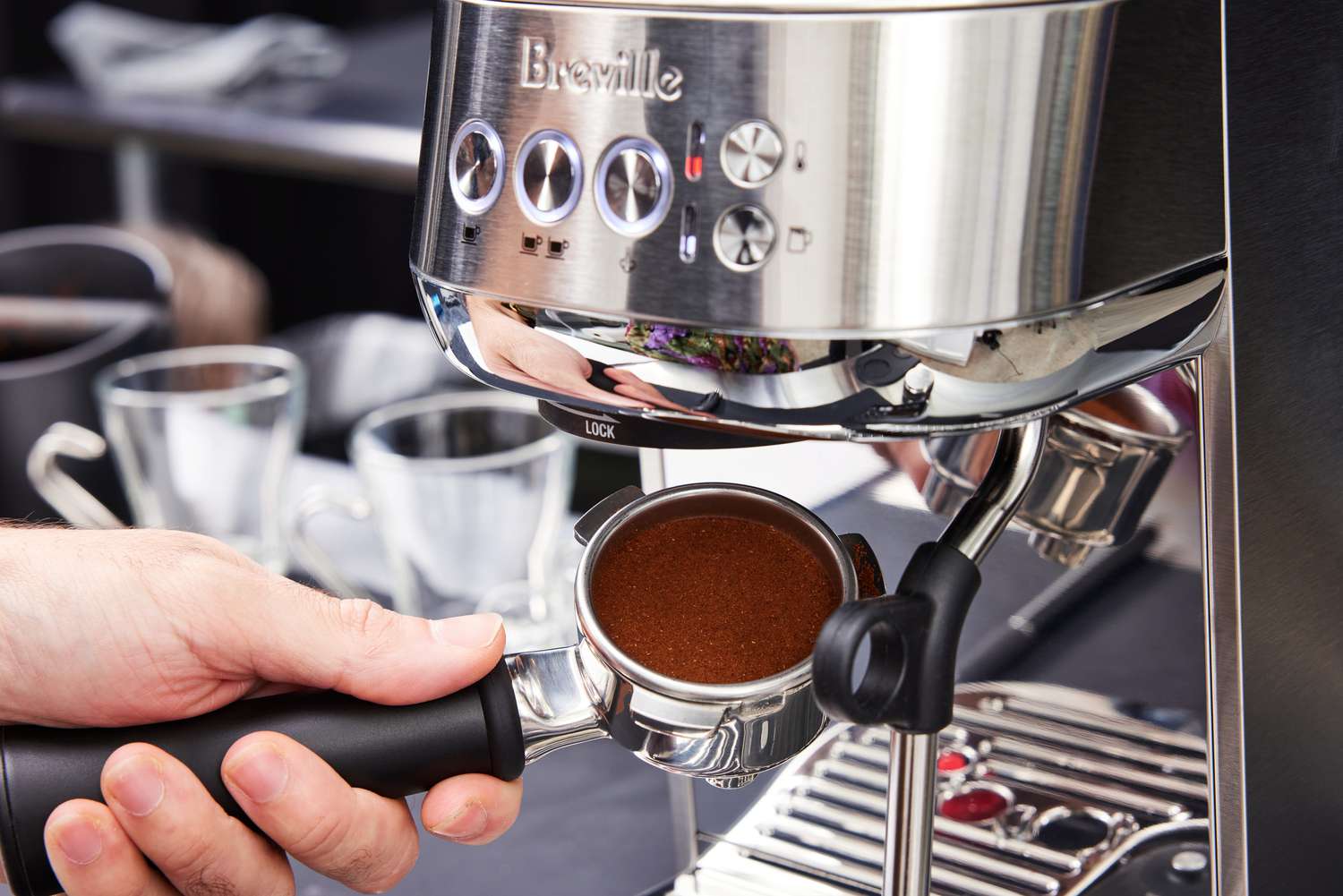 The ground coffee in a portafilter for the Breville Bambino Plus Espresso Machine.
