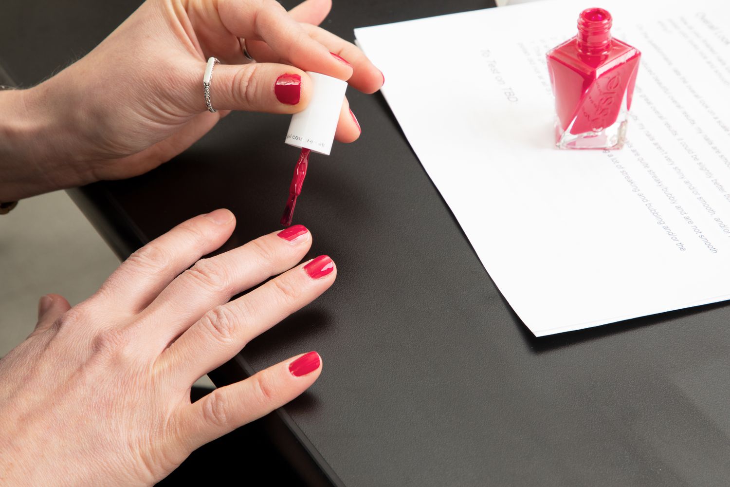 Hand applying Essie Gel Couture Longwear Nail Polish + Top Coat Kit nail polish