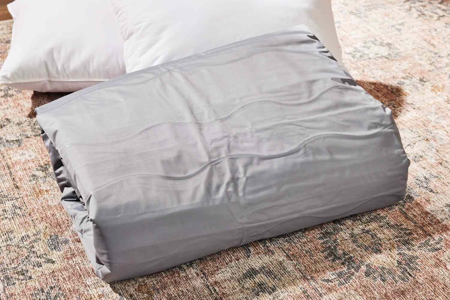 The Brookstone Perfect Queen Air Mattress with Built-in Pump folded up