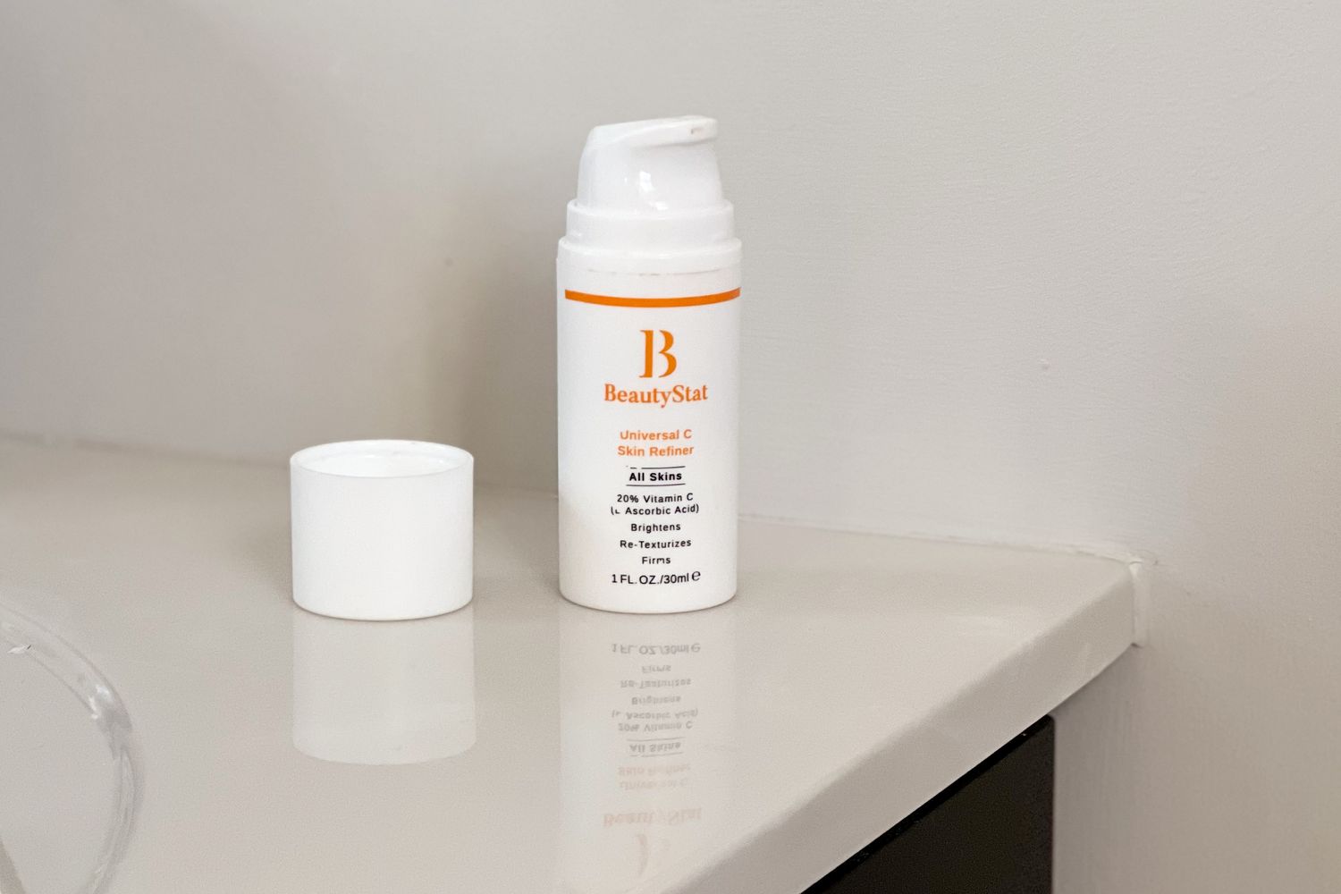 BeautyStat Universal C Skin Refiner displayed on white countertop next to cap