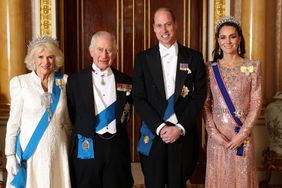 Queen Camilla, King Charles III, Prince William, Prince of Wales and Catherine, Princess of Wales pose for a photograph ahead of The Diplomatic Reception in the 1844 Room at Buckingham Palace on December 05, 2023 in London, England.