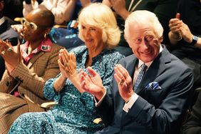 King Charles III, Patron of the Royal Academy of Dramatic Art (RADA), and Queen Camilla sit next to Cynthia Erivo, (L) as they watch an extract of a play performed by third year acting students in the Gielgud theatre during a visit to RADA in London, to celebrate the school's 120th anniversary on May 29, 2024 in London, England.