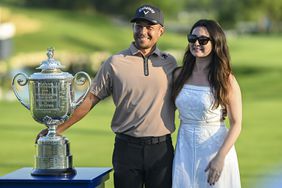 Xander Schauffele and his wife Maya Schauffele smile with the Wanamaker Trophy after his one stroke victory in the final round of the 106th PGA Championship 