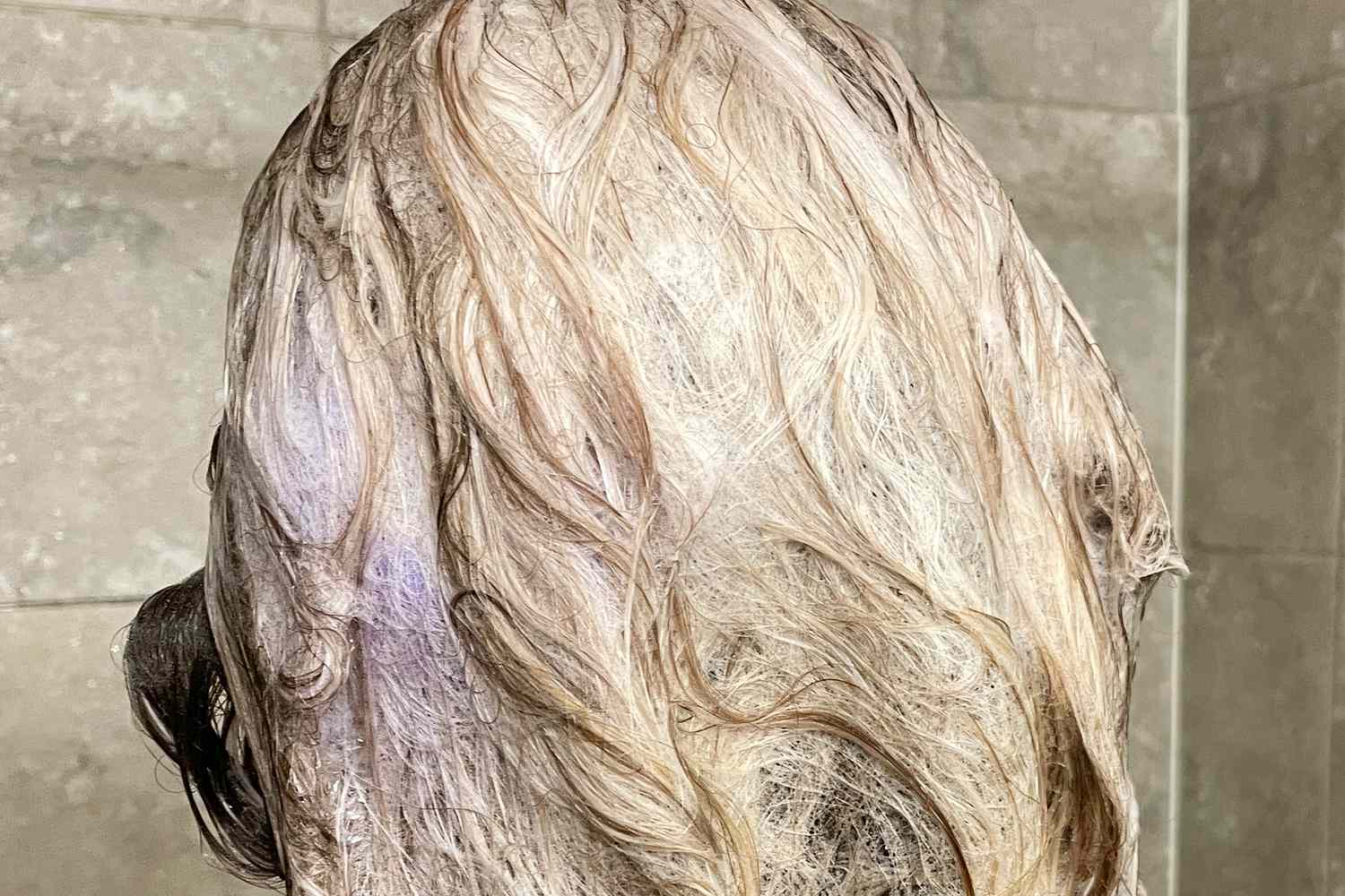 Close-up of a person's wet hair covered in Verb Purple Shampoo