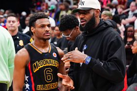 Bronny James #6 of the West team talks to Lebron James of the Los Angeles Lakers after the 2023 McDonald's High School Boys All-American Game