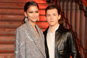 Zendaya and Tom Holland pose at a photocall for "Spider-Man: No Way Home" at The Old Sessions House on December 5, 2021