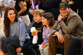 Mila Kunis and Ashton Kutcher and their children look on during the WNBA basketball game between the Indiana Fever and the Los Angeles Sparks 