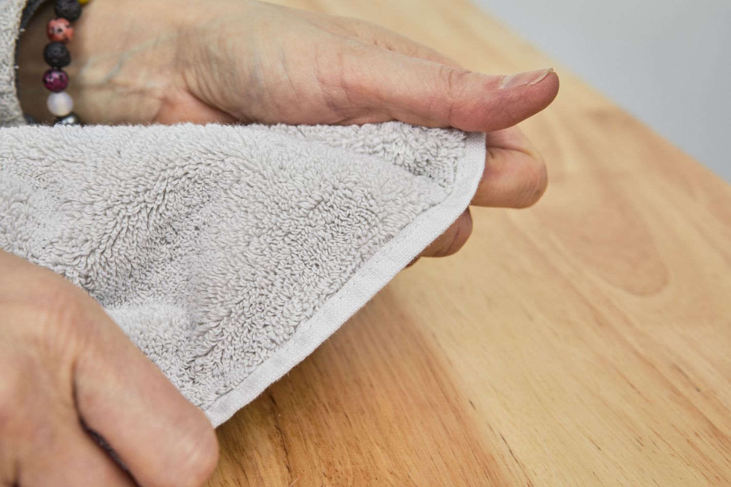 Closeup of hands holding a Boll & Branch Plush Bath Towel 