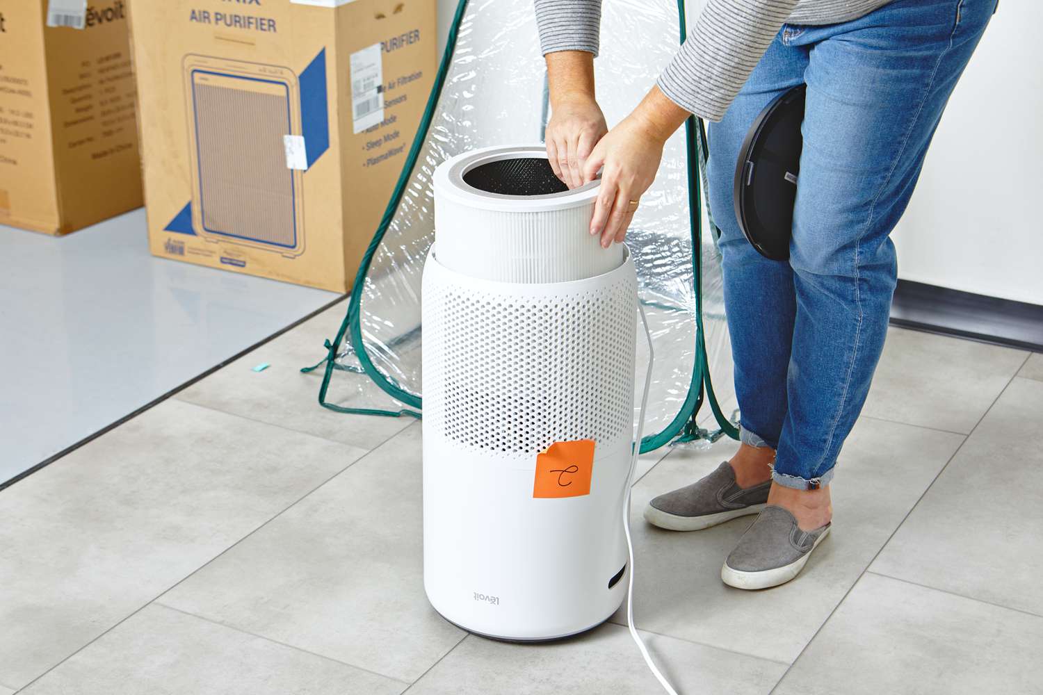 Person removing filter from Levoit Core 400S Smart True HEPA Air Purifier