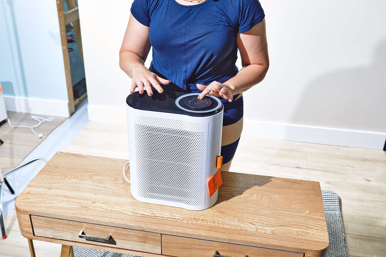 Person pressing buttons on the Aroeve MK04 Air Purifier
