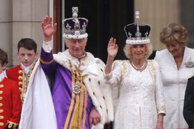 King Charles III and Queen Camilla can be seen on the Buckingham Palace balcony ahead of the flypast during the Coronation of King Charles III and Queen Camilla on May 06, 2023