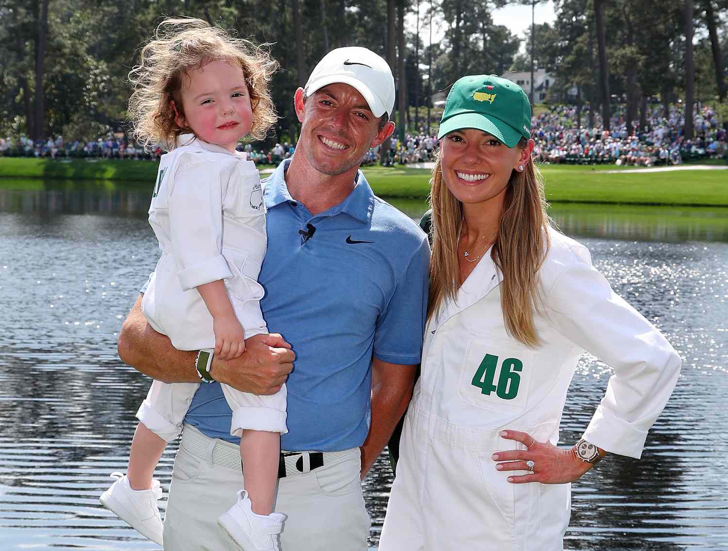 Rory McIlroy of Northern Ireland poses for a photo with his wife, Erica Stoll and daughter Poppy McIlroy during the Par 3 contest prior to the 2023 Masters Tournament at Augusta National Golf Club