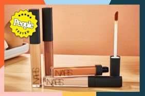 Four tubes of NARS Radiant Creamy Concealer on a wooden table