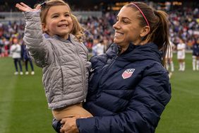 Alex Morgan #13 of the United States holds her daughter, Charlie Carrasco