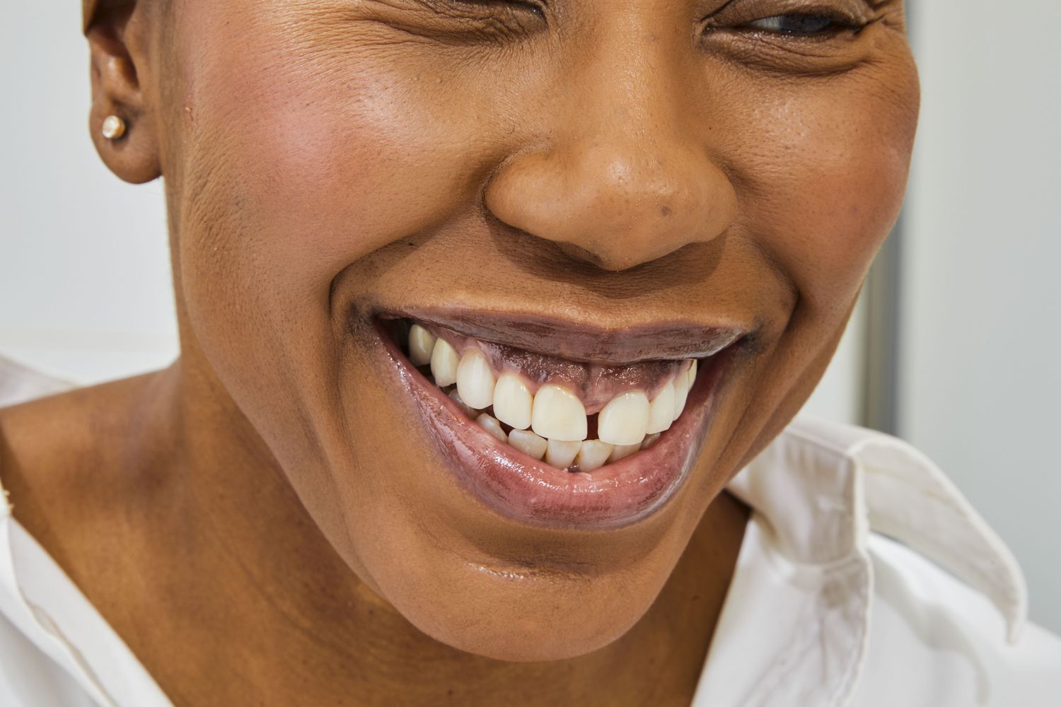 Woman smiling wearing Cay Skin Isle Lip Balm SPF 30 with Sea Moss and Aloe Stem Cells
