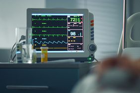 Stock image of heart rate monitor showing vital signs in hospital