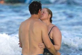 PREMIUM EXCLUSIVE: *NO WEB UNTIL 215PM EST 20TH DEC* Amy Schumer is all smiles as she and husband Chris Fischer enjoy a dip in the Caribbean sea during the holiday season in St Barts.