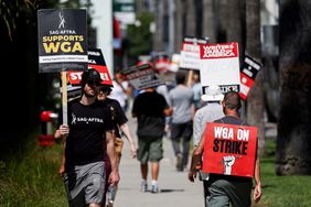 A sign reads 'SAG-AFTRA Supports WGA' as SAG-AFTRA members walk the picket line in solidarity with striking WGA (Writers Guild of America) workers outside Netflix offices on July 11, 2023 in Los Angeles