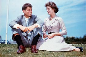 John F. Kennedy and Jackie sit together in the sunshine at Kennedy's family home at Hyannis Port, Massachusetts, a few months before their wedding.