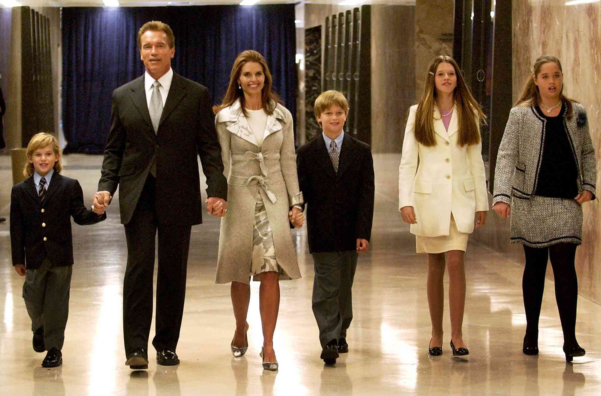 Arnold Schwarzenegger walks with his wife Maria Shriver and their four children to his inaugural ceremony at the State Capitol in Sacramento on Novemeber 17, 2003 in Sacramento, California