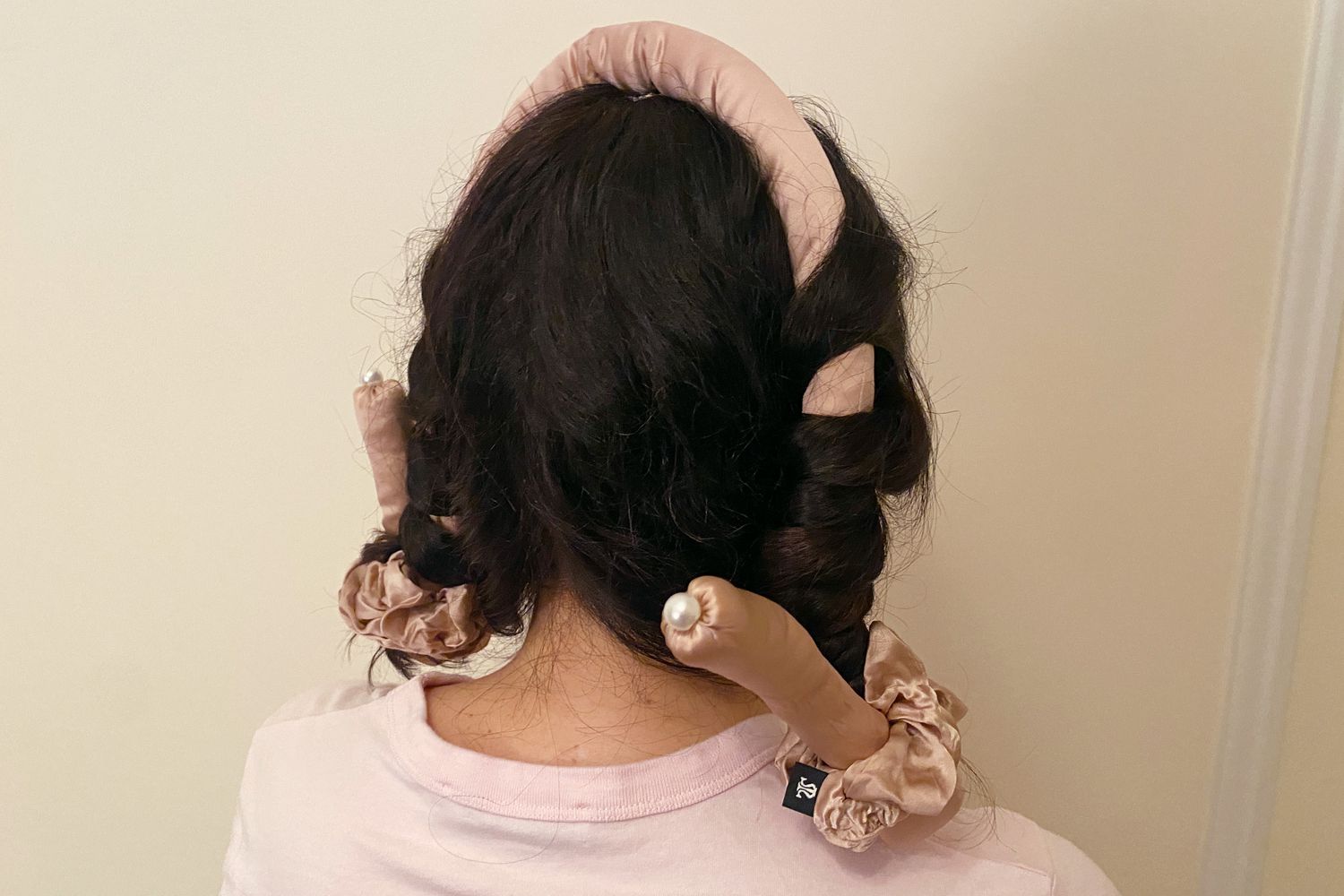 A close up of a person's hair wrapped in the Lilysilk Silk Curling Headband and Scrunchie Set