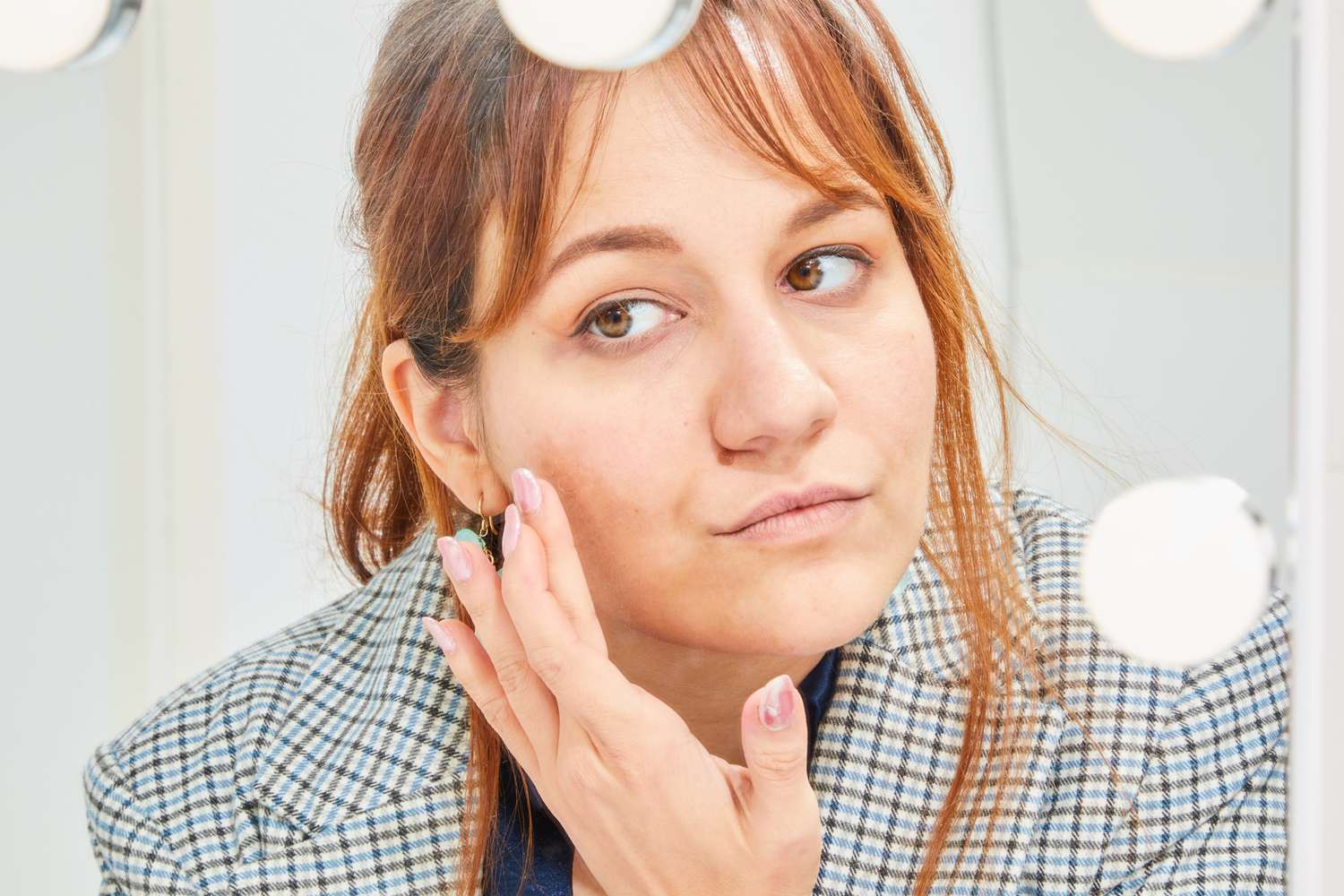 Person applying skin care product to their cheek