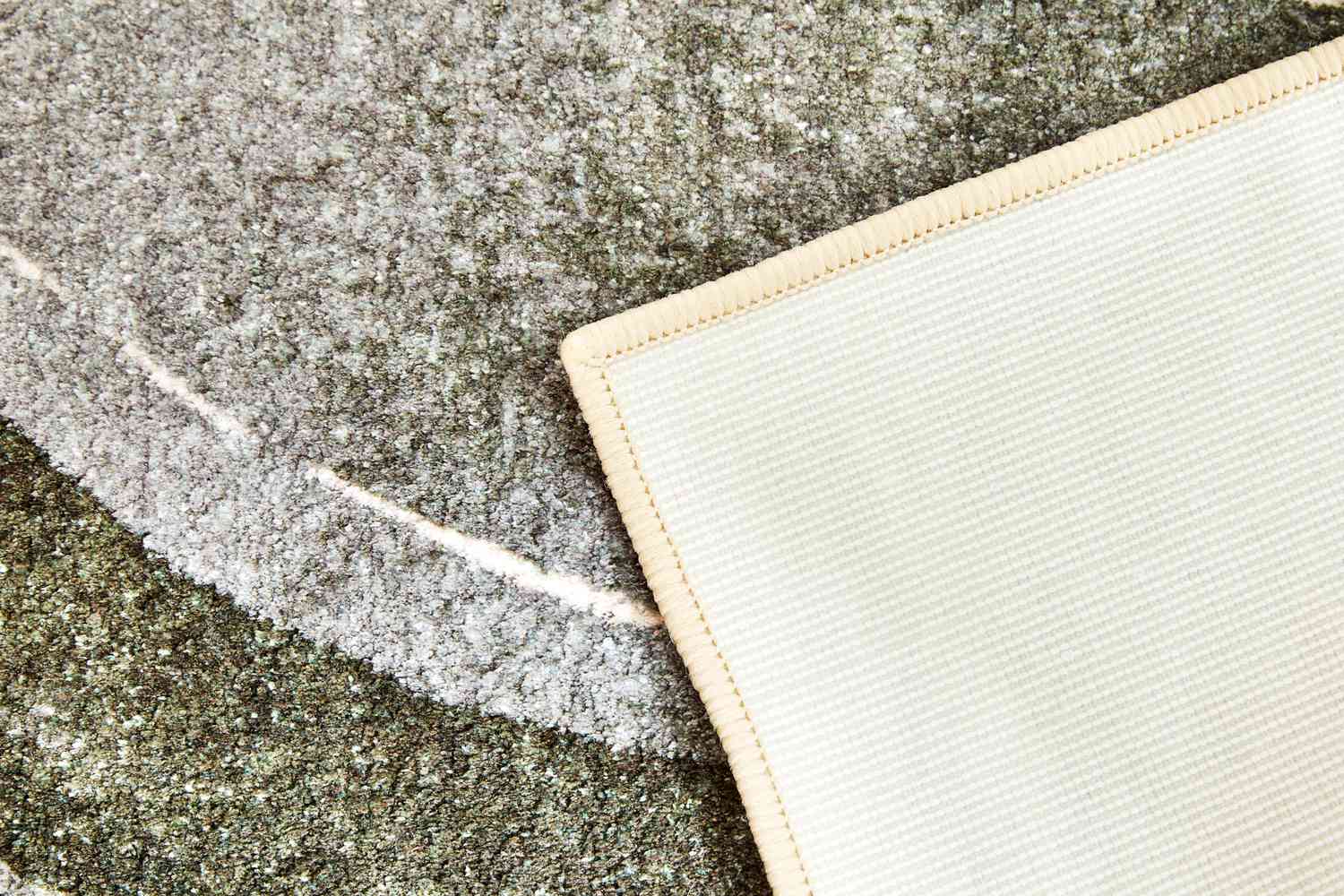 Close up of both sides of the West Elm Waterfall Washable Rug