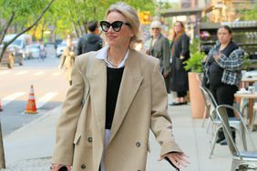 Naomi Watts shows off what appears to be an engagement ring outside the Greenwich Hotel while walking her dog in New York City. Naomi then appears to hide the ring by covering it with her cellphone.