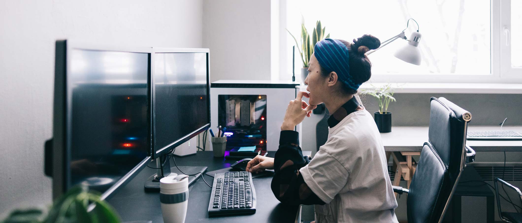 Developer sitting in front of her computer in an office