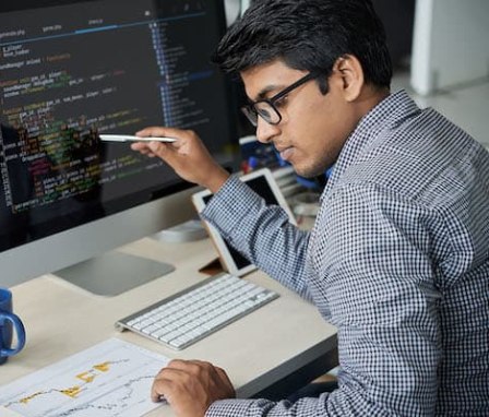 Man working on code on computer