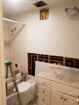 Photo of Repipe Home Hero - Plumbing & Pipe Specialist - San Diego, CA, US. Lines delivering water to shower , toilet , and sink going up to 2nd story bathroom