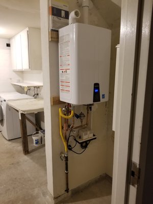 Photo of Repipe Home Hero - Plumbing & Pipe Specialist - San Diego, CA, US. Tankless water heater NPE-240A with recirculating line and condensation pump , after repipe is done.