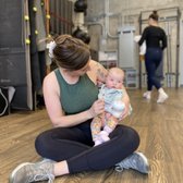Postnatal mom hanging out with baby after lifting!