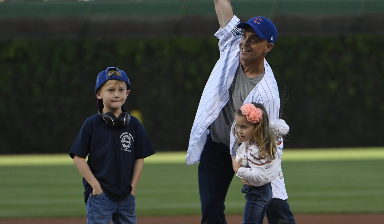 CHICAGO, IL - MAY 16: Television Actor and star of Chicago Fire David Eigenberg throws out a ceremonial first pitch as his daughter Myrna and son Louie watch before the game between the Chicago Cubs and the Cincinnati Reds on May 16, 2017 at Wrigley Field in Chicago, Illinois. (Photo by David Banks/Getty Images)