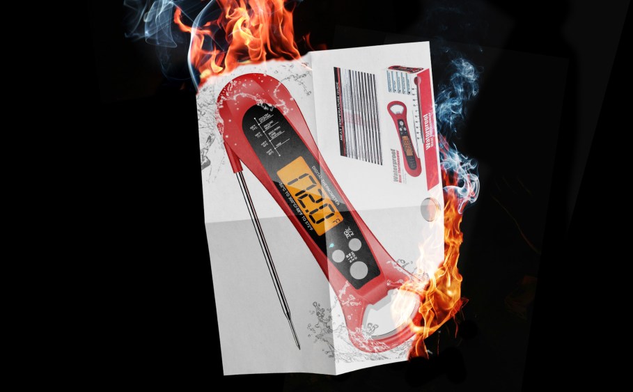 A red meat thermometer with flames on either side