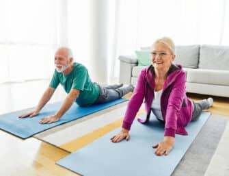 An older couple exercises to enhance mobility.