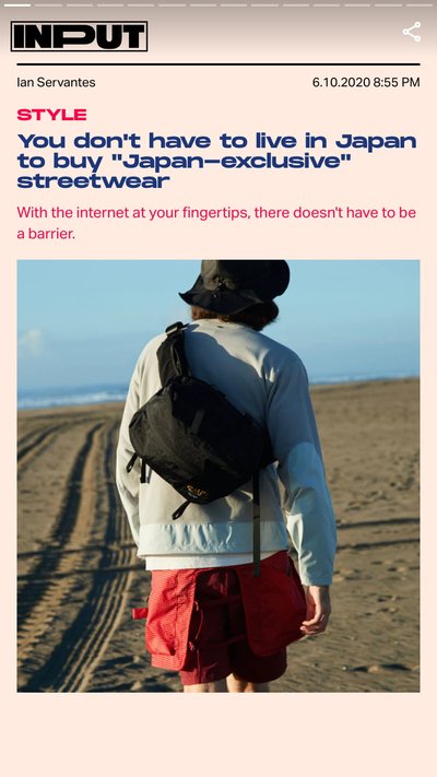 A person wearing streetwear walking along the beach
