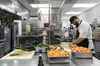 Chefs prepare vegetables in a Google kitchen