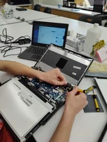 A student repairs a Chromebook computer