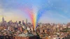 Illustration of the New York City skyline with a rainbow of small squares bursting out of an area of the city where the Stonewall Inn sits