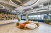 The reception of Google's new office in São Paulo where you can see the Google logo, some sofas, plants and a large glass window