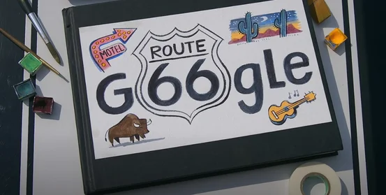 A photo of a table with the Google logo with the Route 66 icon inside of it.