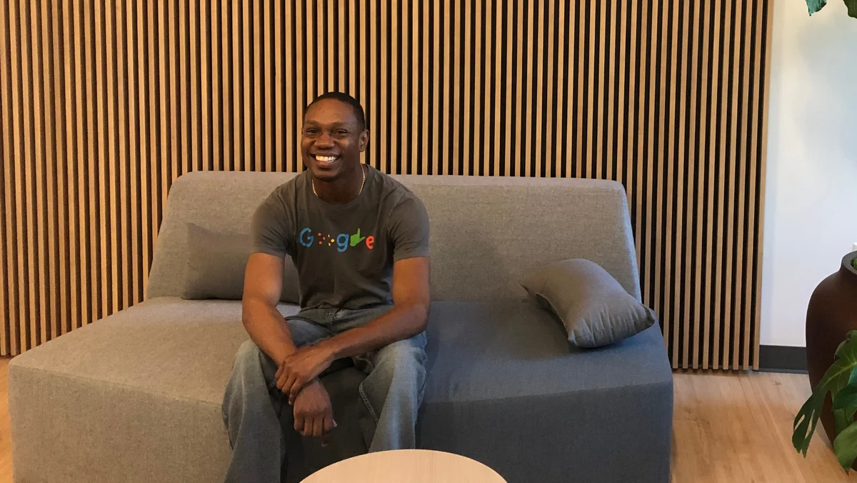 Jerry sits on a couch inside a Google office.