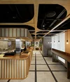 A ramen bar in Google’s Tokyo Stream office. There is a counter with wooden slats for standing-style seating.