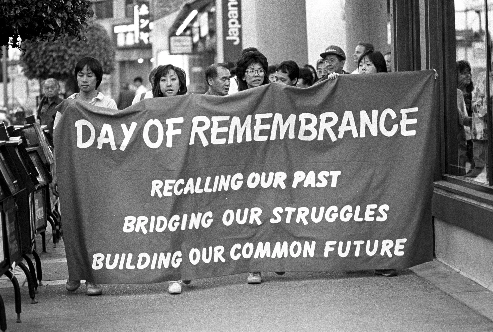 Photo showing a group of Japanese Americans march to commemorate the unjust mass evacuation and incarceration of Japanese Americans during World War II.